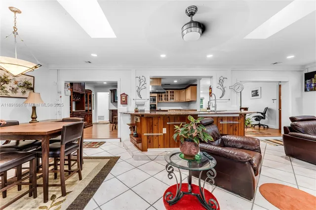 a living room with furniture kitchen view and a table