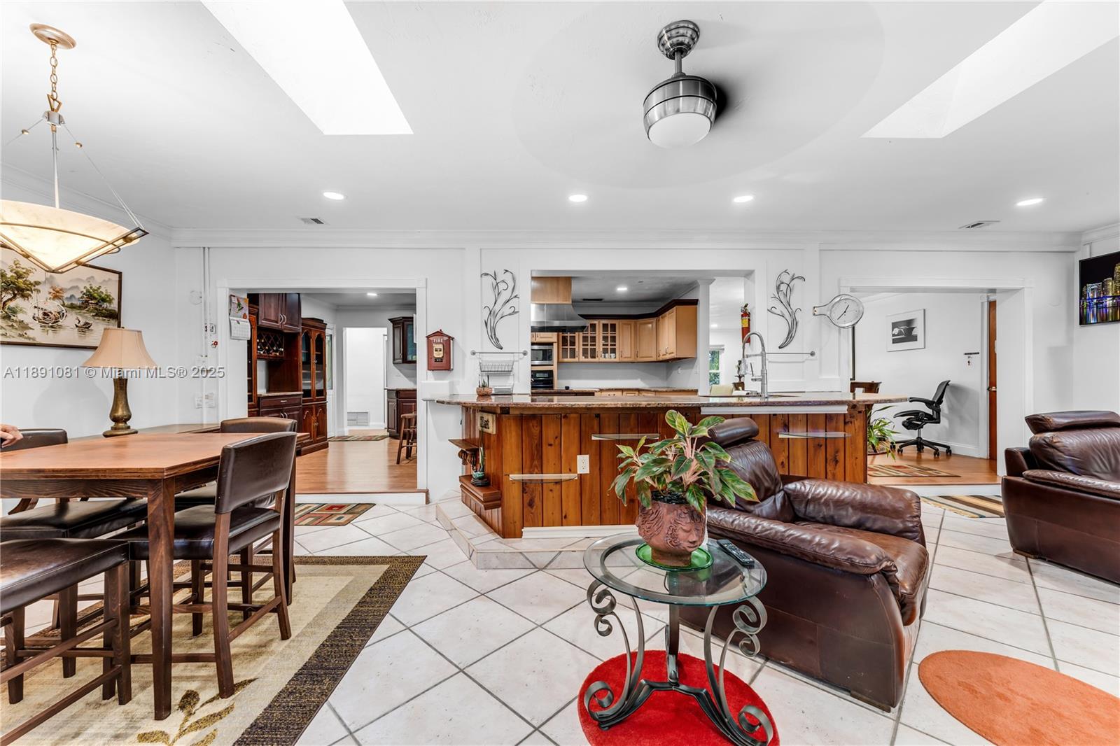 9081 Southwest 140th Street Miami, FL 33176 - Photo 12 of 29 a living room with furniture kitchen view and a table
