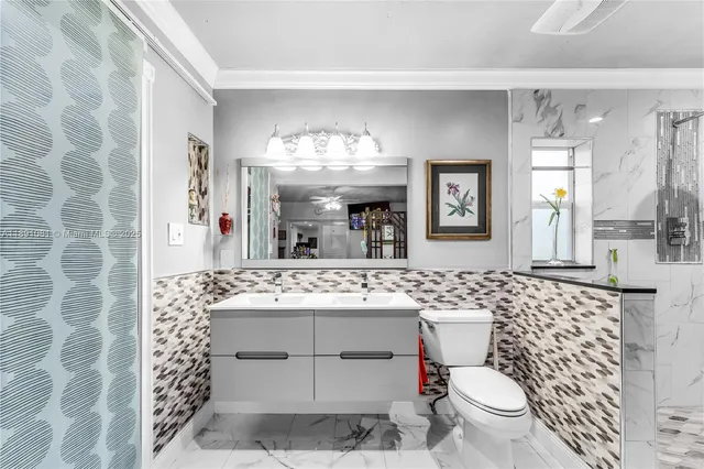 a bathroom with a sink toilet mirror and shower
