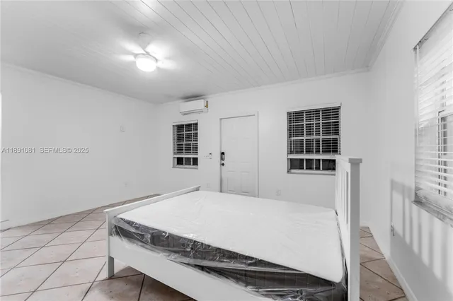 a spacious bedroom with a bed and a window