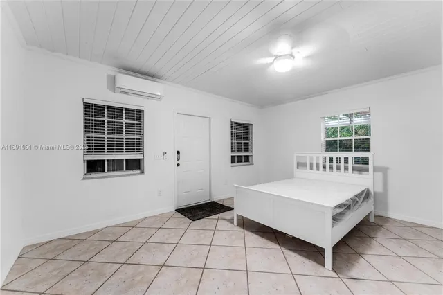 a spacious bedroom with a bed and a window