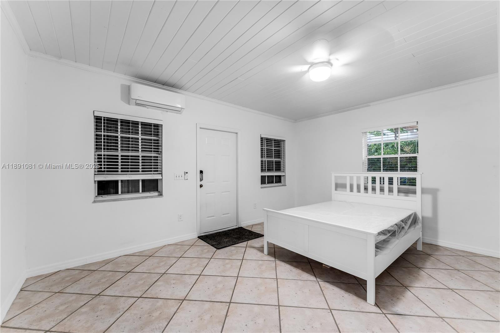 9081 Southwest 140th Street Miami, FL 33176 - Photo 29 of 29 a spacious bedroom with a bed and a window