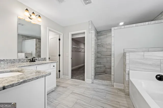 a bathroom with a bathtub and shower