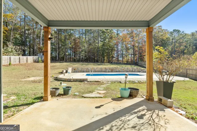 an aerial view of a house with a yard