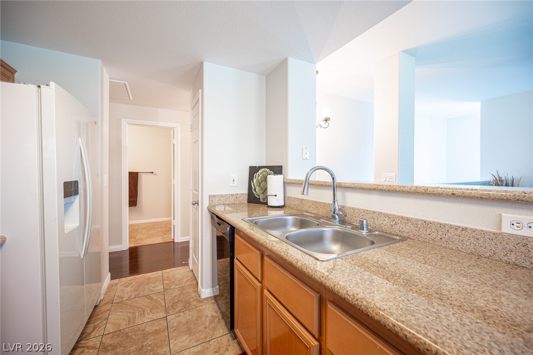 7701 West Robindale Road, Unit 274 Las Vegas, NV 89113 - Photo 14 of 38 This bright kitchen features durable tile floors and ample counter space, perfect for daily living.