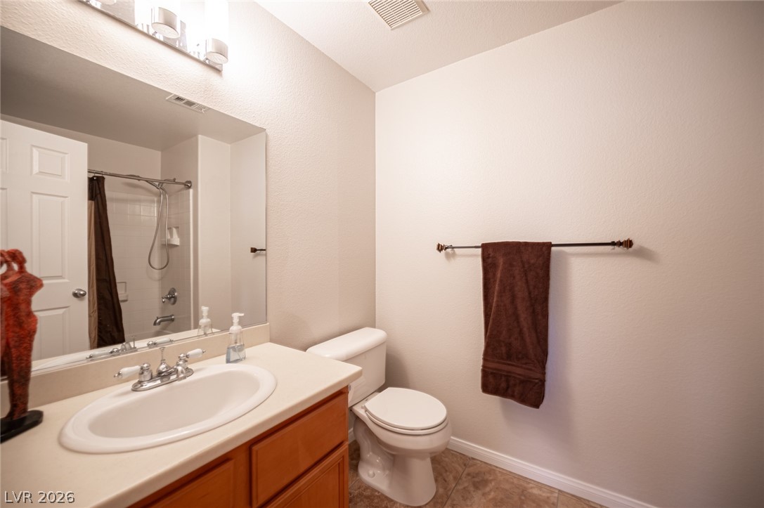 7701 West Robindale Road, Unit 274 Las Vegas, NV 89113 - Photo 23 of 38 This bathroom features a sleek vanity, mirror, toilet, and a combination shower/tub.