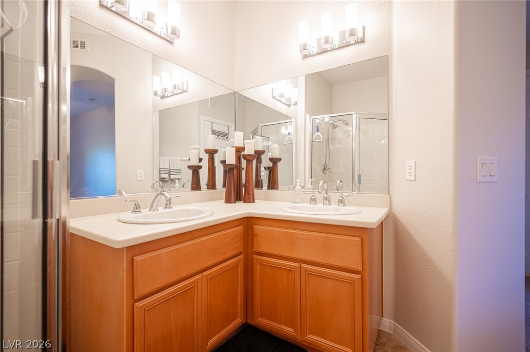 7701 West Robindale Road, Unit 274 Las Vegas, NV 89113 - Photo 32 of 38 This spacious primary bathroom features dual vanities and a convenient shower for comfortable daily routines.