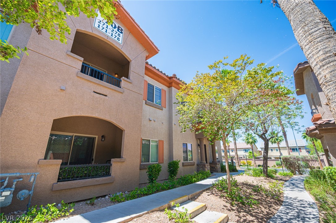 7701 West Robindale Road, Unit 274 Las Vegas, NV 89113 - Photo 37 of 38 This multi-story dwelling features stucco construction, offering balconies and patios amidst a landscaped setting.