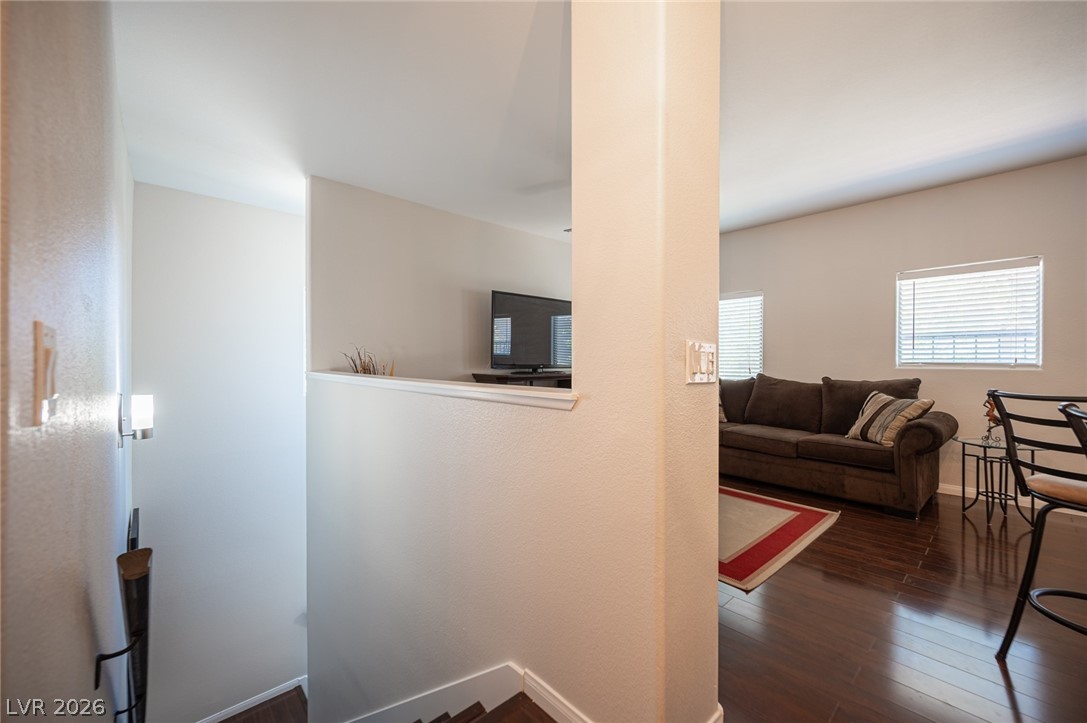 7701 West Robindale Road, Unit 274 Las Vegas, NV 89113 - Photo 4 of 38 This inviting space features rich hardwood flooring, creating a warm and cohesive ambiance.
