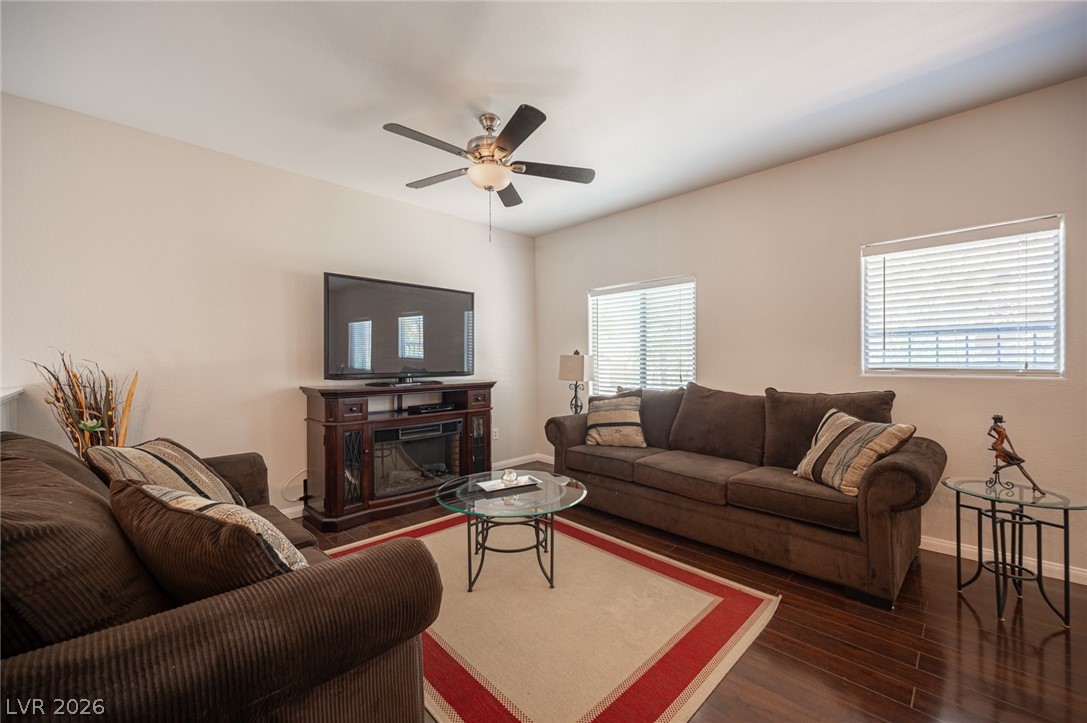 7701 West Robindale Road, Unit 274 Las Vegas, NV 89113 - Photo 5 of 38 This inviting living space features dark hardwood flooring, a ceiling fan, and ample natural light.