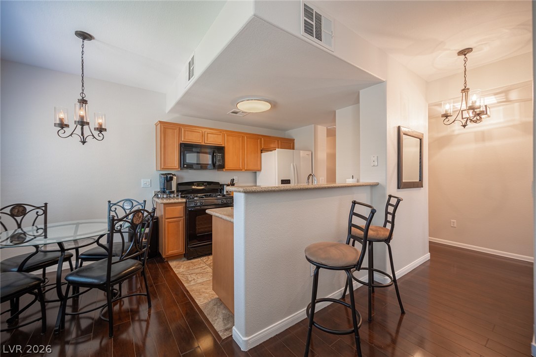 7701 West Robindale Road, Unit 274 Las Vegas, NV 89113 - Photo 9 of 38 This inviting kitchen features a breakfast bar, ample cabinetry, and modern appliances for daily living.