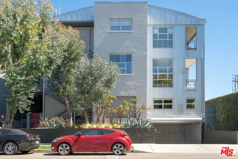 a front view of a building with parking space