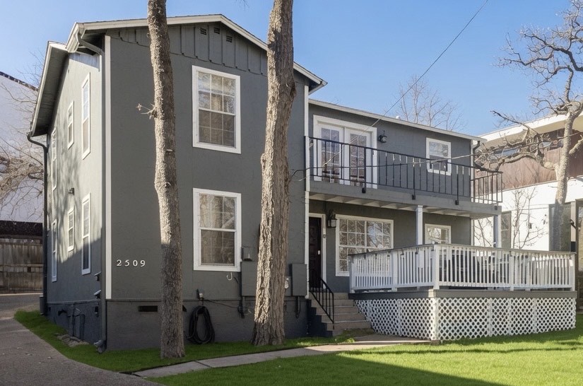 2509 Quarry Road, Unit A Austin, TX 78703 - Photo 1 of 3 A dark-toned exterior offers a charming patio and an upper-level balcony, ideal for outdoor enjoyment.