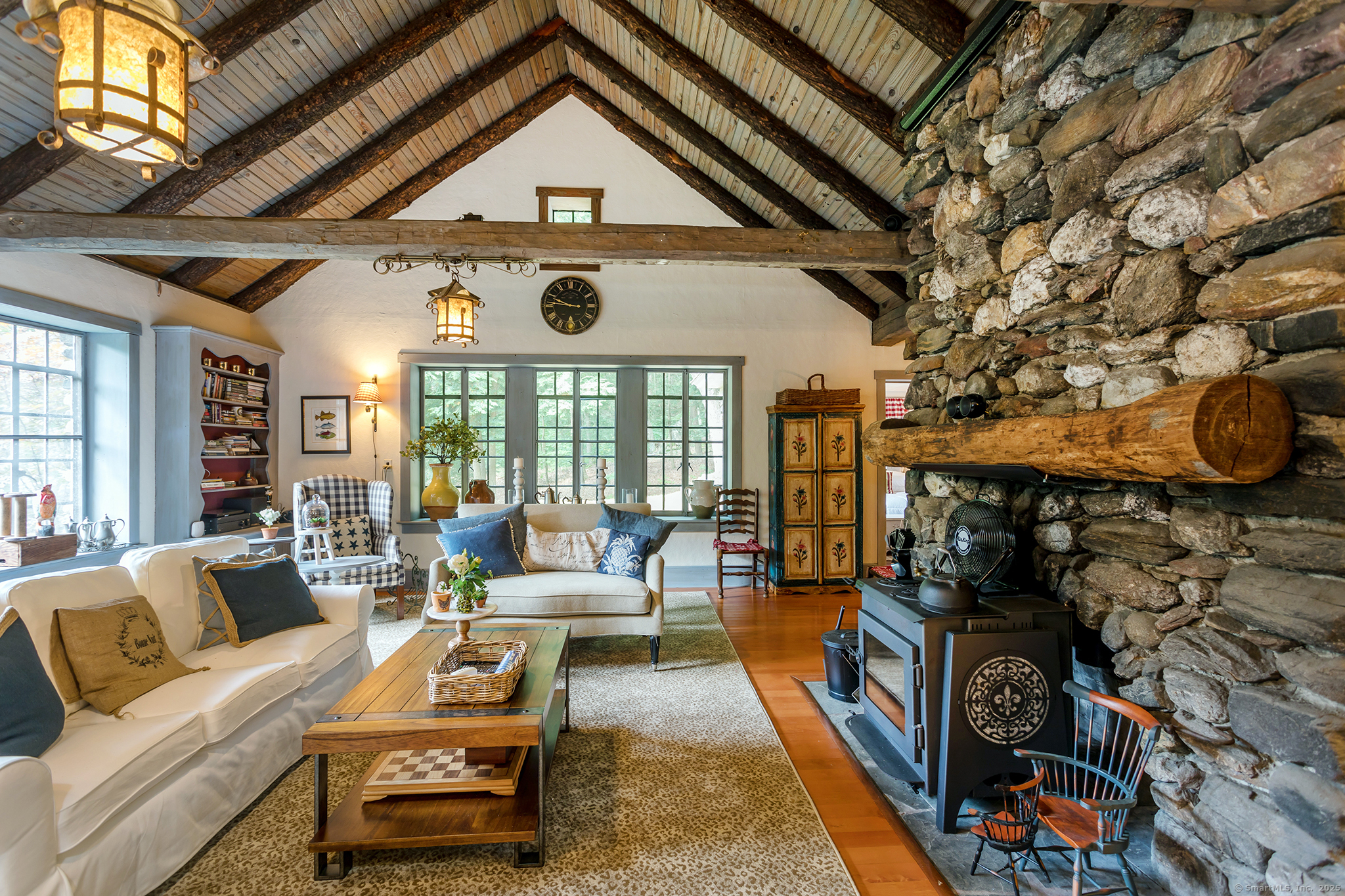 60 Leach Hollow Road Sherman, CT 06784 - Photo 15 of 24 a living room with furniture a fireplace and a table