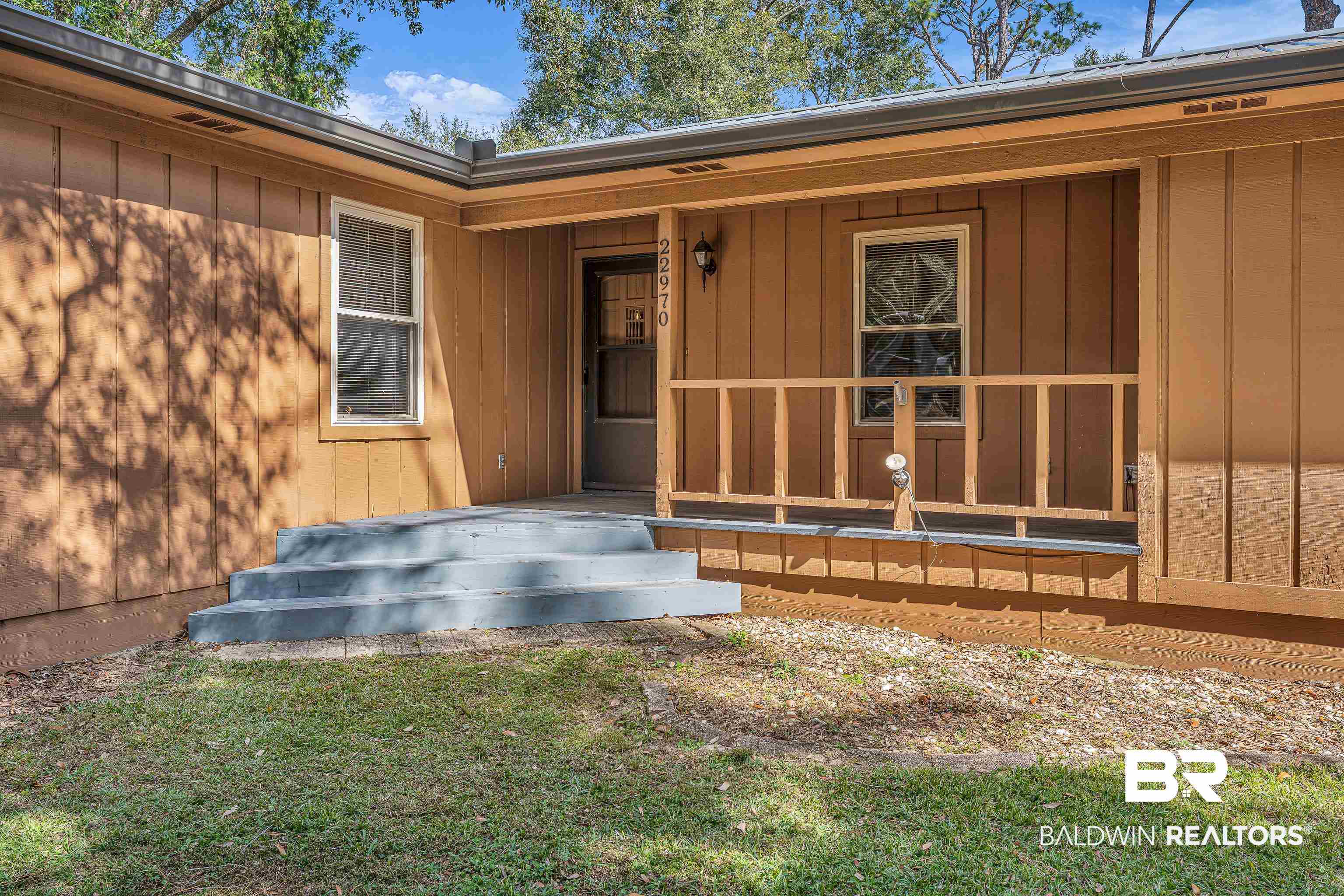22970 River Road South Daphne, AL 36526 - Photo 2 of 48 Property entrance featuring board and batten siding