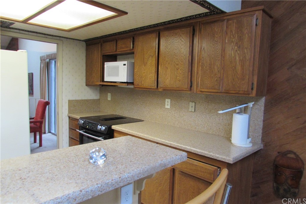 4413 Via Majorca Cypress, CA 90630 - Photo 20 of 46 a kitchen with stainless steel appliances granite countertop a sink stove and cabinets