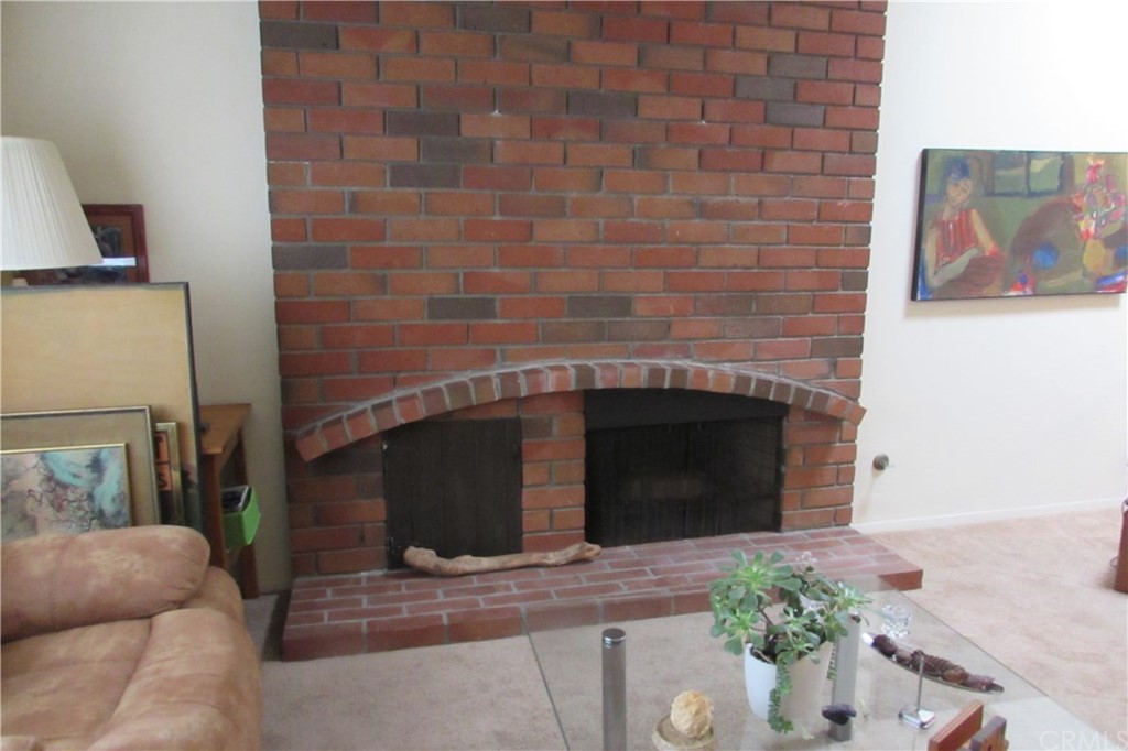 4413 Via Majorca Cypress, CA 90630 - Photo 9 of 46 a living room with a fireplace and a potted plant