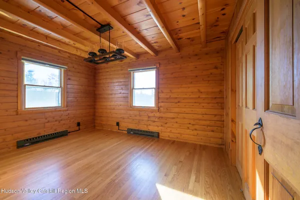 a bathroom with a granite countertop sink a toilet a mirror and shower