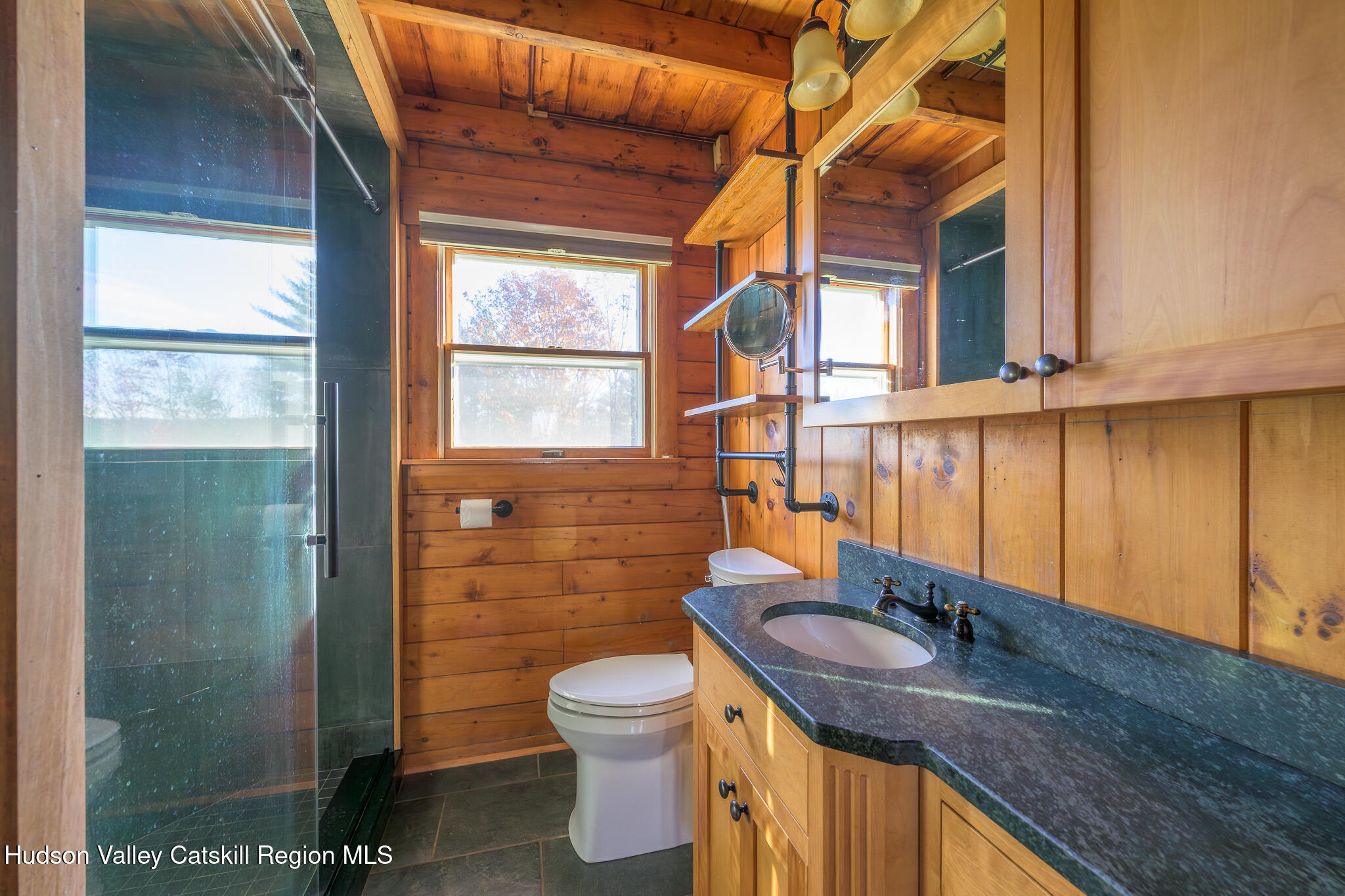 10 7 Bridges Road Old Chatham, NY 12136 - Photo 17 of 42 a bathroom with a granite countertop sink a toilet a mirror and shower