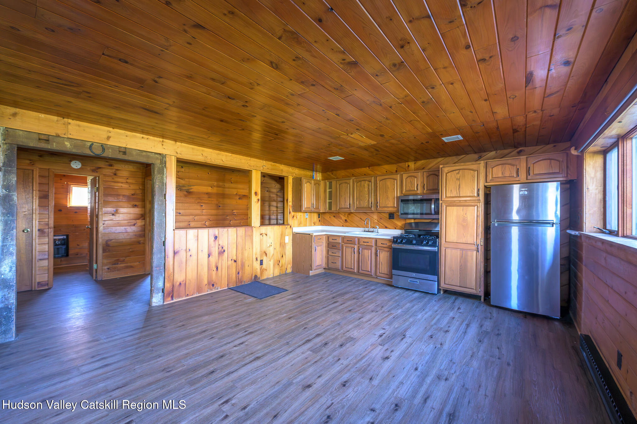 10 7 Bridges Road Old Chatham, NY 12136 - Photo 27 of 42 a kitchen with stainless steel appliances wooden floors and wooden cabinets