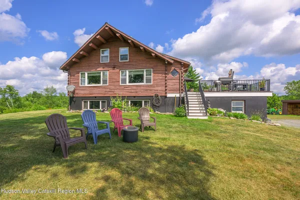 a view of a house with a yard porch and sitting area