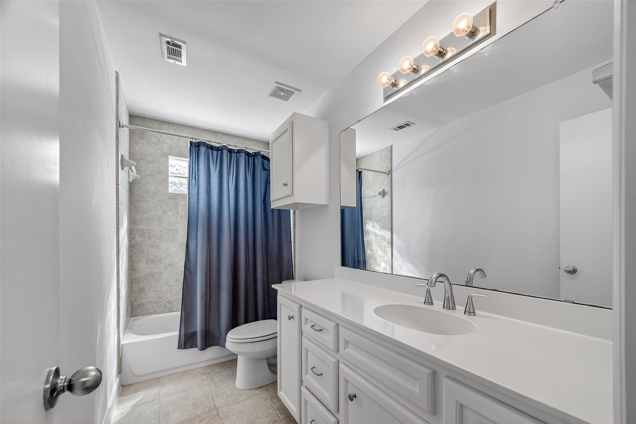 5951 S Loop East, Unit 47 Houston, TX 77033 - Photo 24 of 37 Bright and modern full guest bathroom featuring a large mirror, dual sinks, and ample cabinet space. Perfect for overnight guests or roommates.