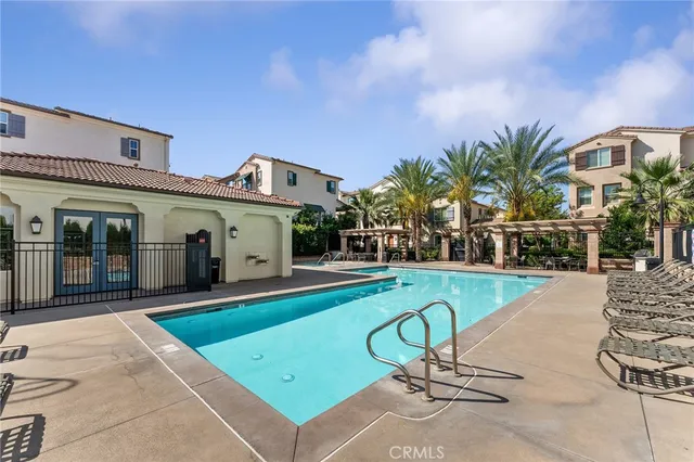 a view of a house with swimming pool and sitting area