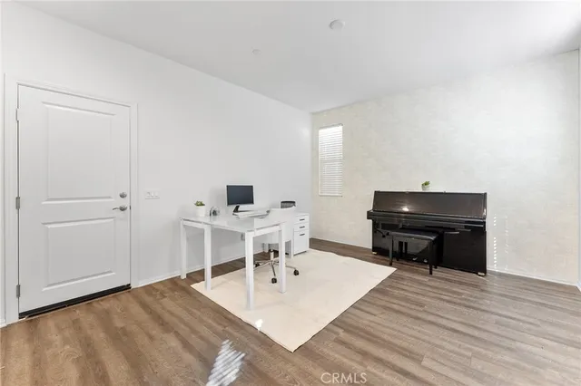 a living room with a couch and piano table