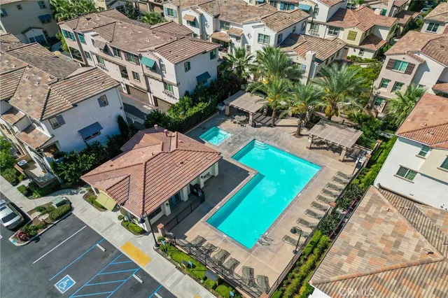 an aerial view of a house with a garden and swimming pool