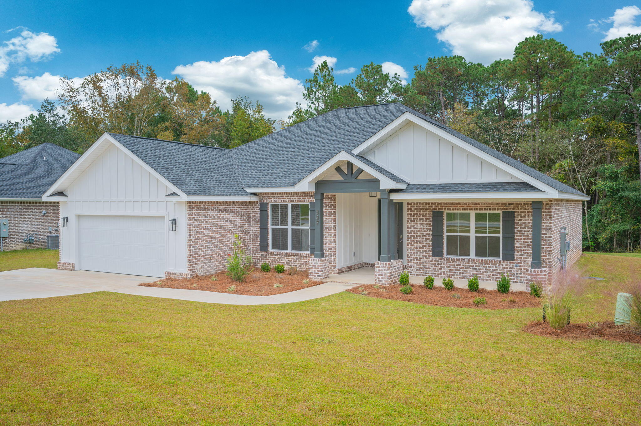 a front view of house with yard outdoor seating and barbeque oven