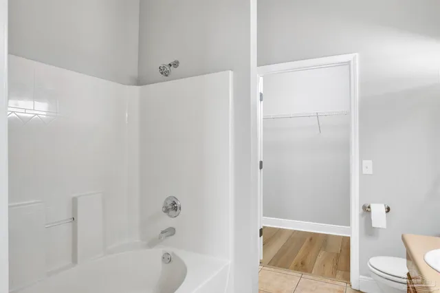a bathroom with a tub and shower