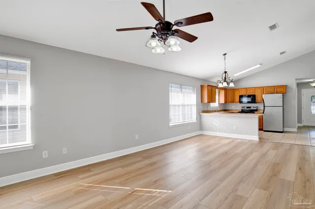 a view of a kitchen with a stove cabinets and wooden floor