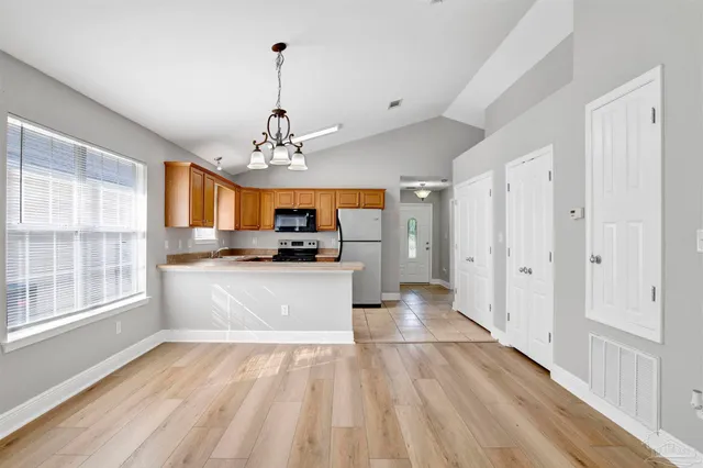 a view of a kitchen with microwave and cabinets