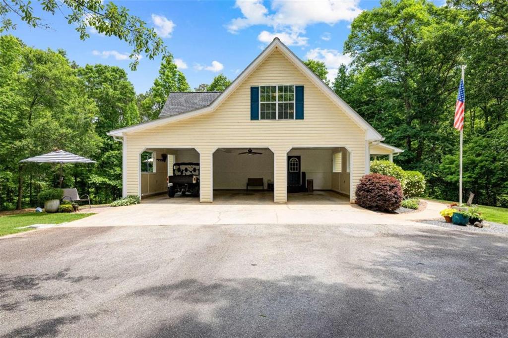 128 Byrom Road Senoia, GA 30276 - Photo 64 of 83 a view of a white house with a yard and potted plants