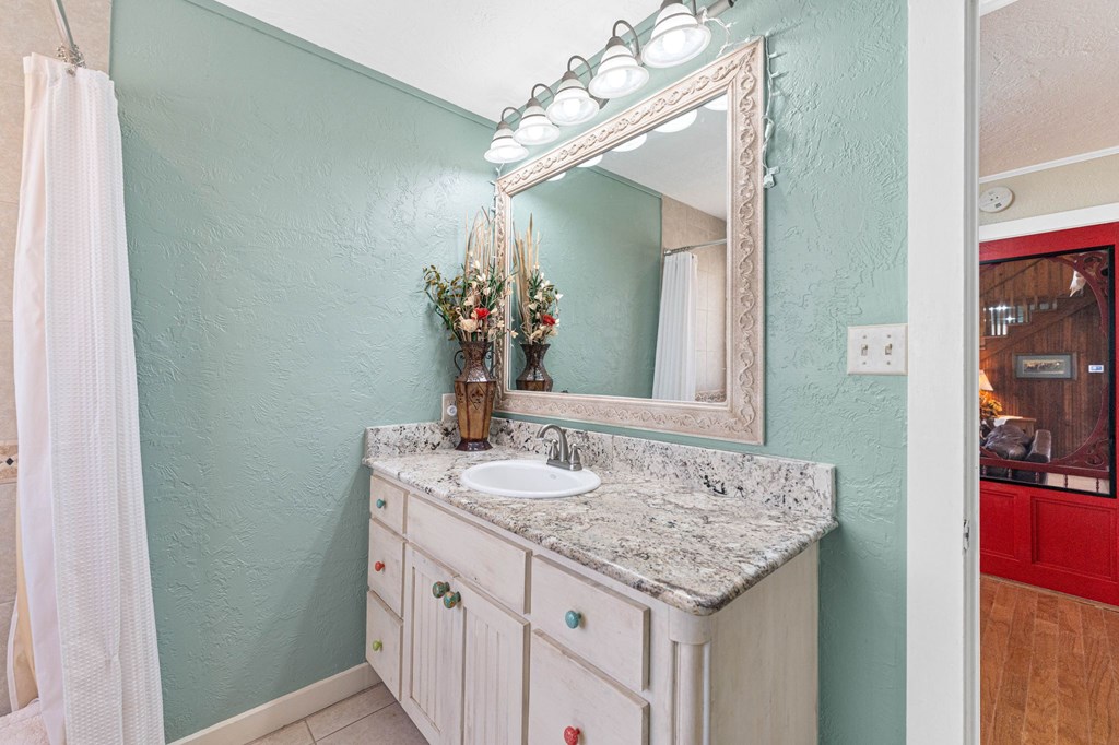 43 High Street Road Comfort, TX 78013 - Photo 45 of 90 a bathroom with a granite countertop sink and a mirror
