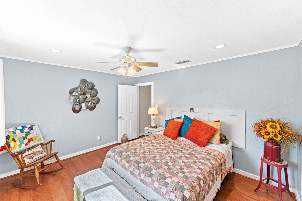 43 High Street Road Comfort, TX 78013 - Photo 48 of 90 a bedroom with a bed and a chandelier