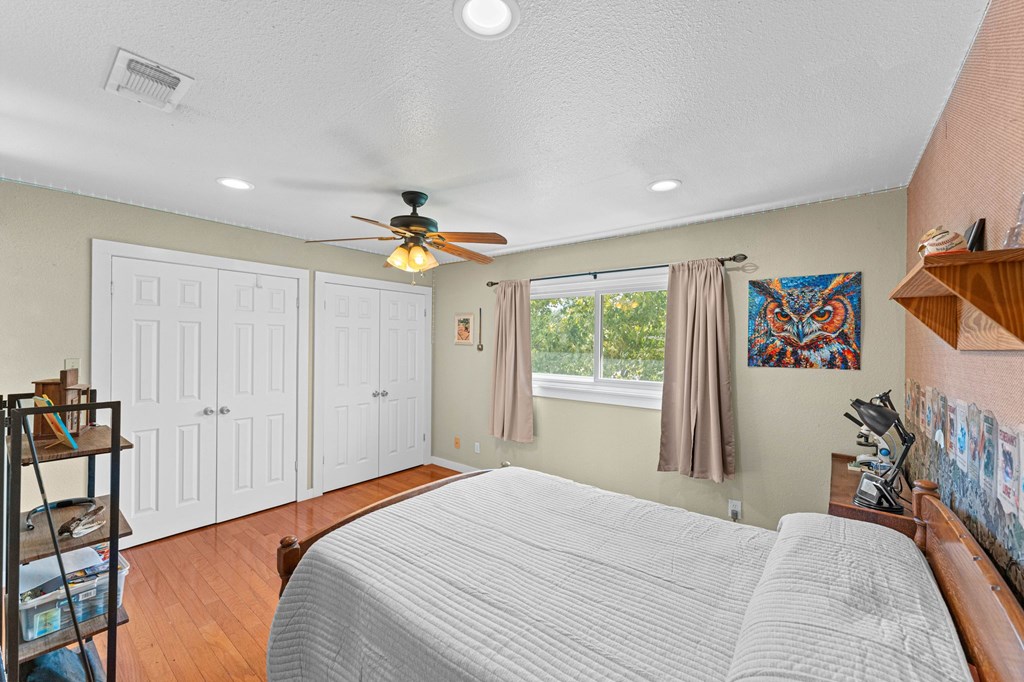 43 High Street Road Comfort, TX 78013 - Photo 68 of 90 a bedroom with a bed and a chandelier
