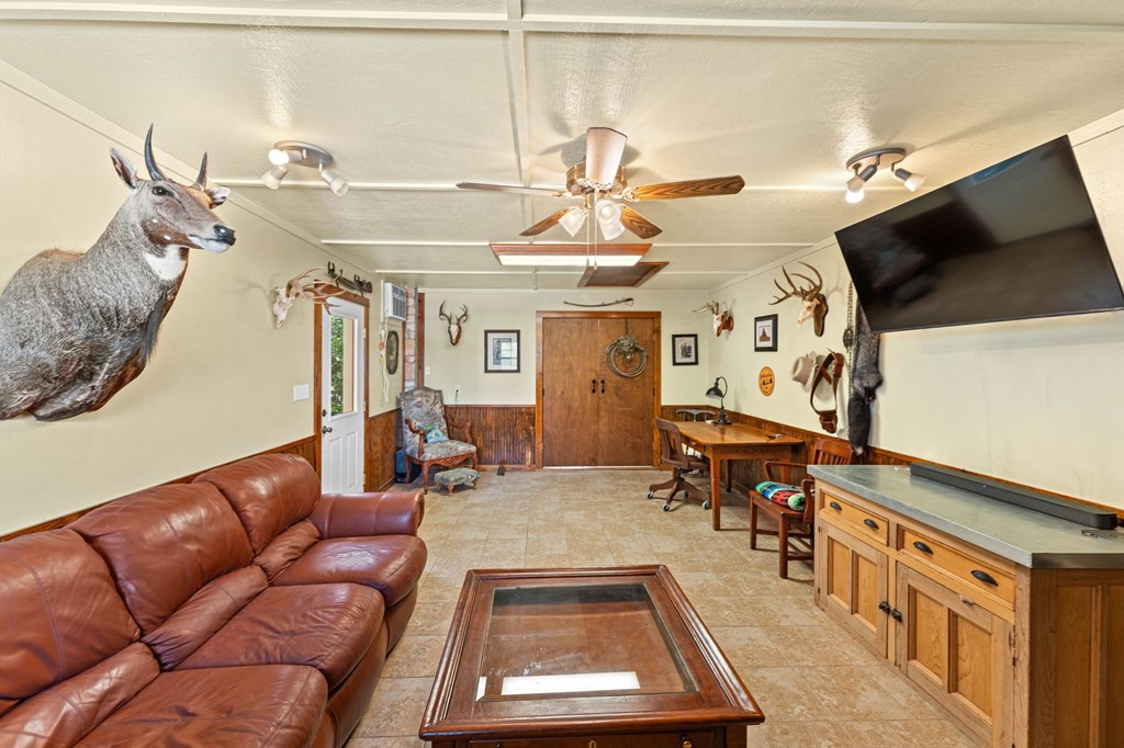 43 High Street Road Comfort, TX 78013 - Photo 77 of 90 a living room with furniture a flat screen tv and kitchen view