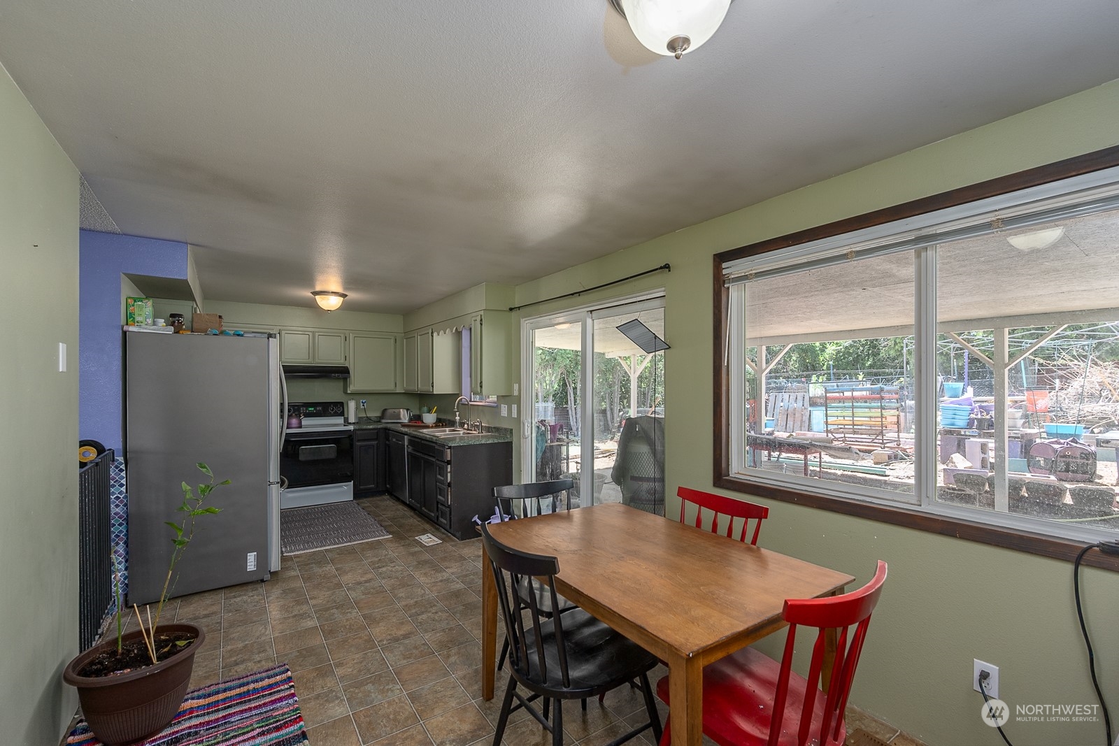 329 Maringo Road Ephrata, WA 98823 - Photo 7 of 18 a dining room with furniture a rug a flat screen tv and a large window