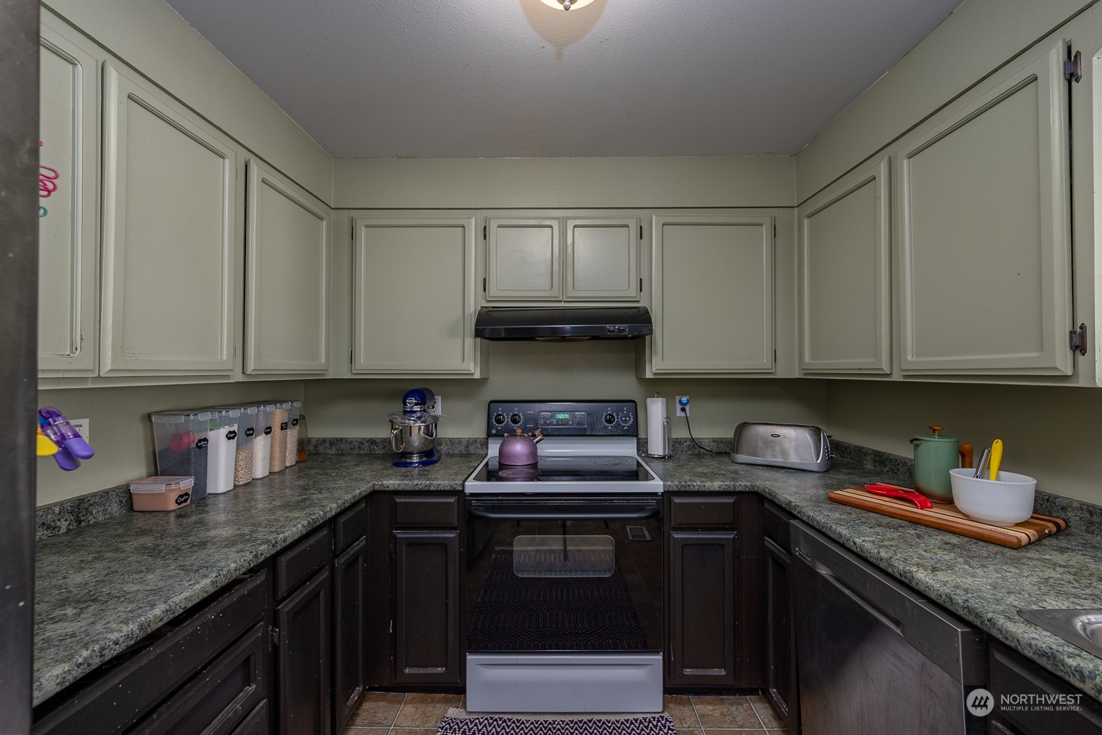 329 Maringo Road Ephrata, WA 98823 - Photo 10 of 18 a kitchen with granite countertop a sink cabinets and stainless steel appliances