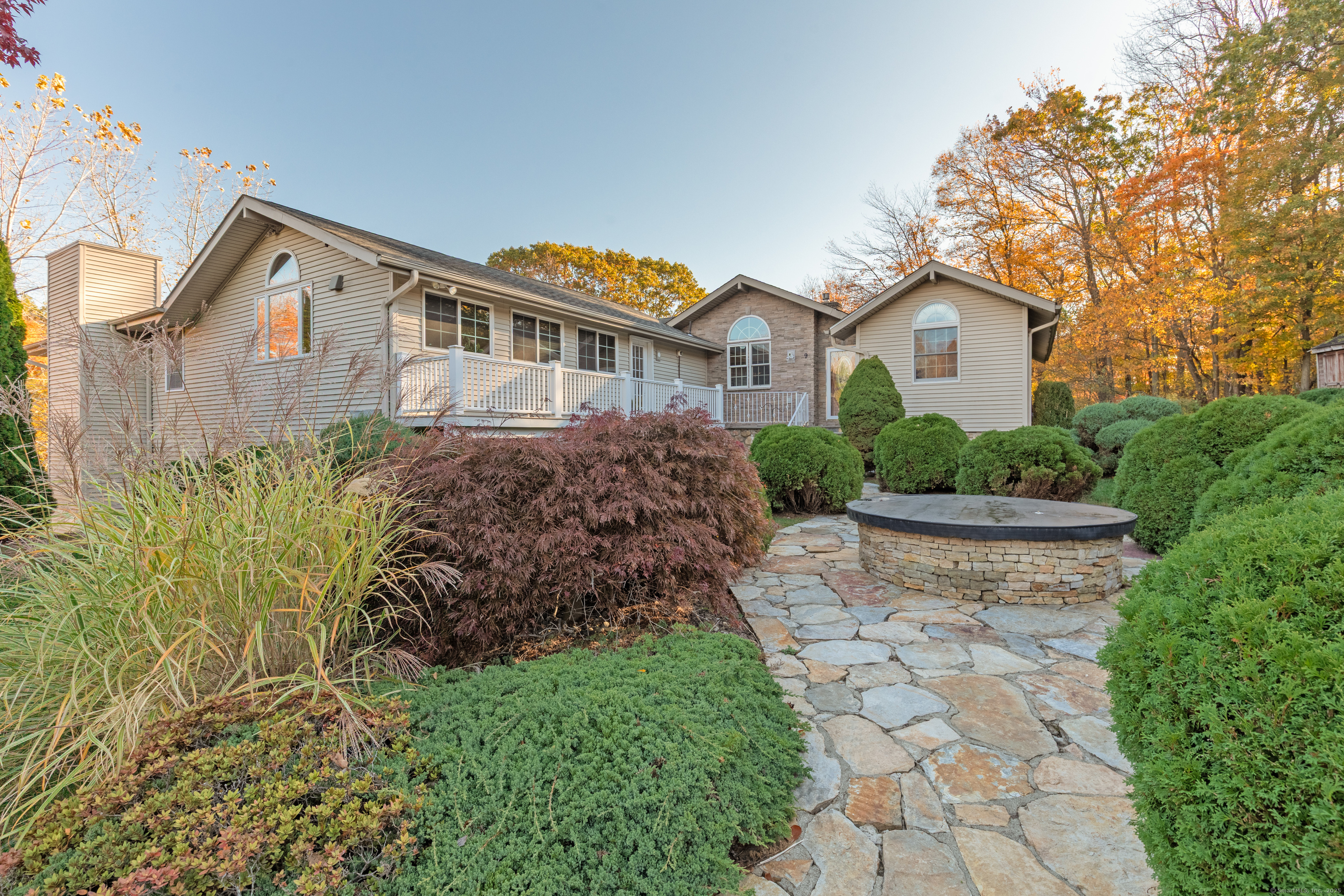 a front view of a house with a yard and fountain