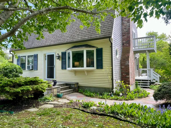 a front view of a house with a garden