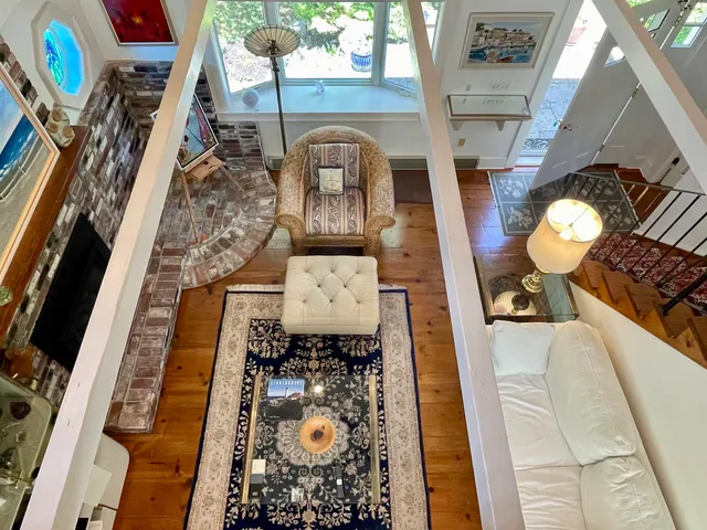 a picture of a living room with furniture and a rug