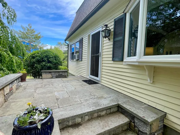a view of a chair and table in the patio