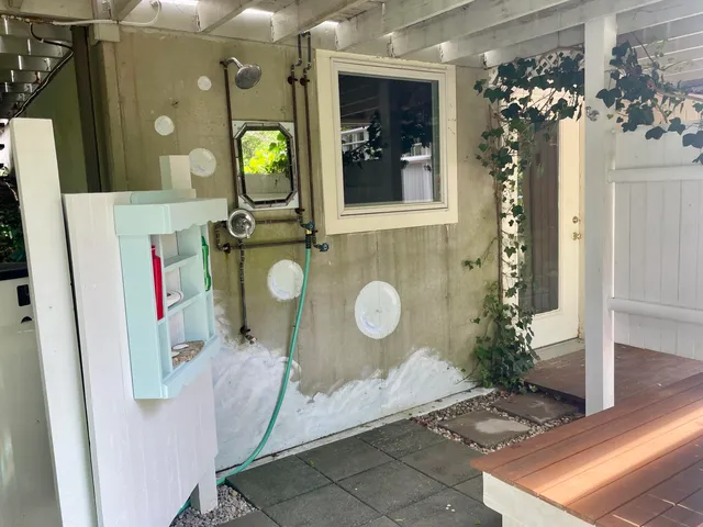 a view of a tennis court with trees in the background