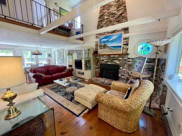 a living room with furniture fireplace and a flat screen tv