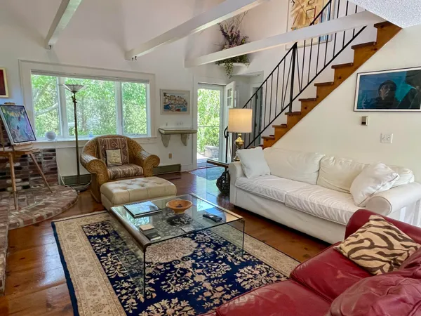 a living room with furniture and a rug