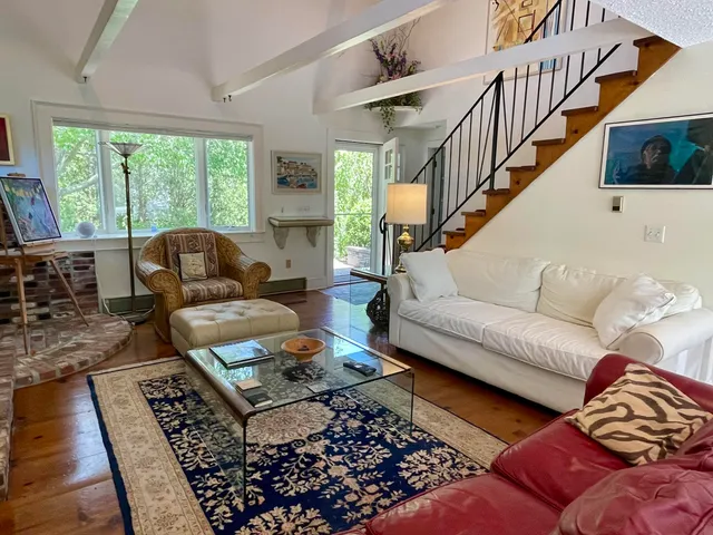 a living room with furniture and a rug