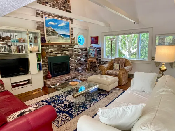a living room with furniture fireplace and flat screen tv