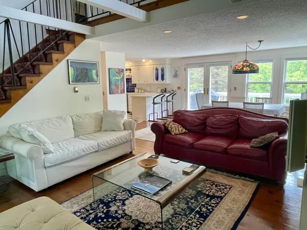 a living room with furniture rug and window